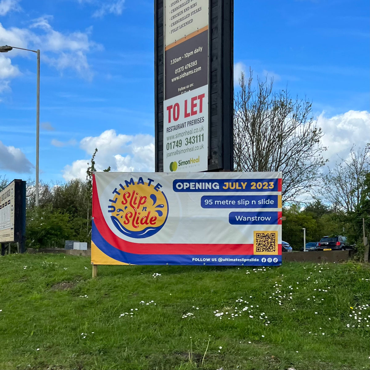 Ultimate Slip n Slide brand design on roadside banner